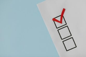 A simple white paper checklist with one red checkmark, ideal for concepts like completion or approval.