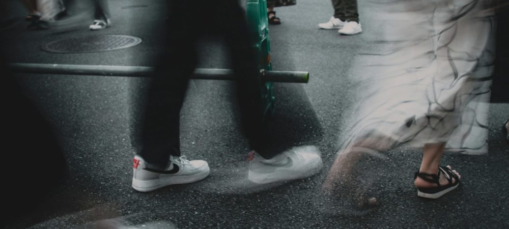 A group of people walking down a street