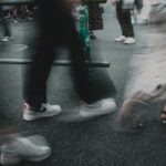 A group of people walking down a street